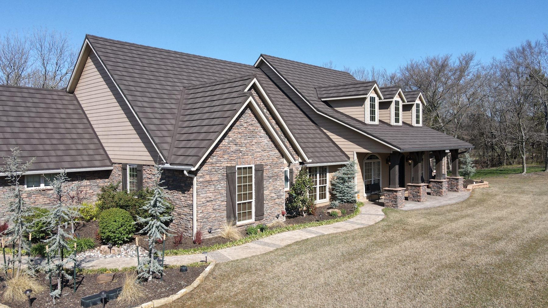 Stone-coated steel shake-style roof on a stone and siding home